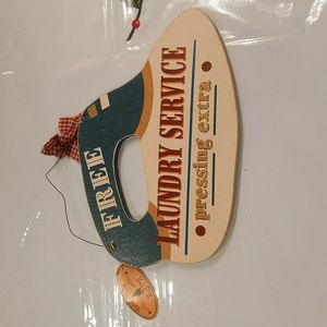 $1 with bundle iron "Free Laundry Service Pressing Extra" hanging sign